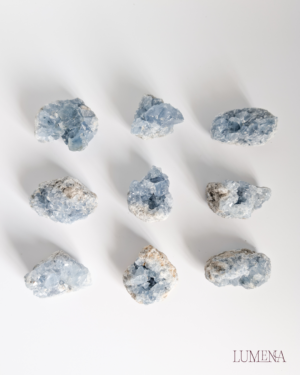 Image shows nine beautiful blue celestite clusters in various shades of blue, all different shapes and sizes. Blue Celestite is a very calming crystal, making it perfect for bedrooms, especially children's rooms
