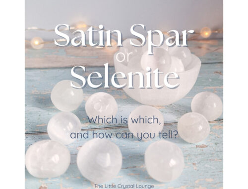 Image shows a collection of small Satin Spar Selenite spheres on a vintage blue wooden table. The text overlay reads "Satin Spar or Selenite? Which is which and how can you tell?"