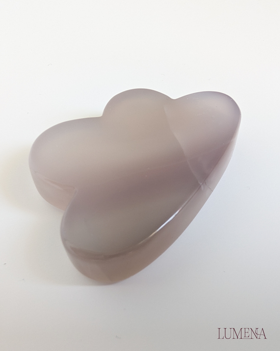 Image shows a grey agate crystal carved into a cloud shape.